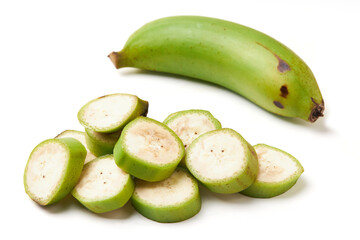 Group of unripe bananas (green) isolated on white background, unripe bananas are versatile and high in fiber. Top view of sliced banana inside, seeds and green banana peel.