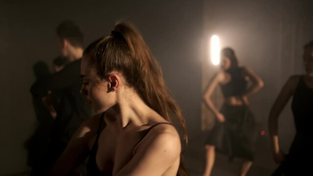 A group of dancers are rehearsing a dance on stage. The concept of modern dance.