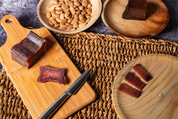 Tacos and slices of cured tuna loin, called in Spain mojama, a delicacy of Arab origin, together with some fried almonds, top view.