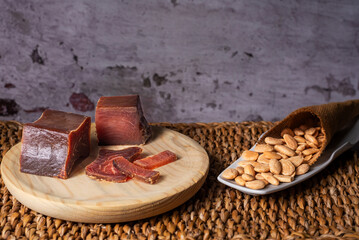 Tacos and slices of cured tuna loin, called in Spain mojama, a delicacy of Arab origin produced on the southern coast of Spain, accompanied by fried almonds, close-up.