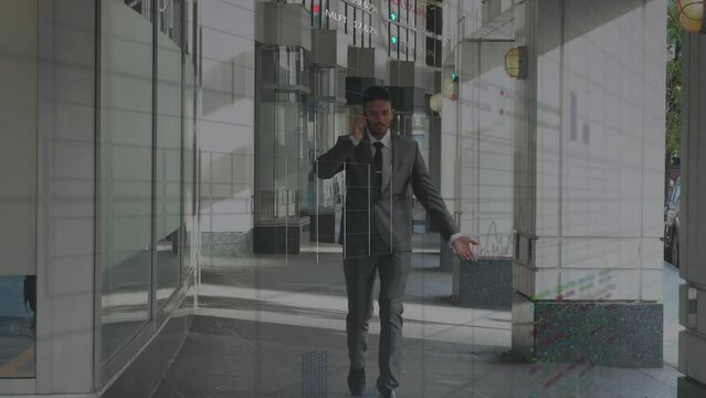 Animation of stock market data processing over biracial businessman talking on smartphone at office