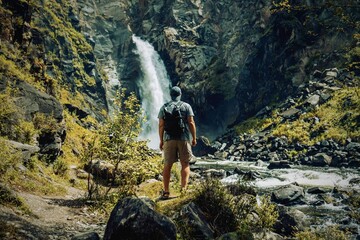 Person at waterfall in summer 
