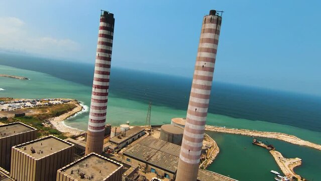 FPV Flying Between Large Columns Of Smoke Pipe Thermal Power Plant On Sunny Day, Zouk, Lebanon