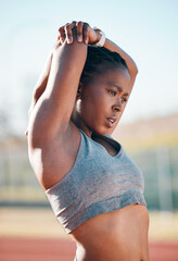 Sports, exercise and woman stretching outdoor at a stadium for workout, training and warm up....