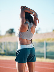 Stretching, sports and exercise with a woman outdoor on a track for running, training or workout....