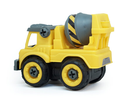 Side view of Yellow plastic concrete mixer truck toy isolated on white background. construction vechicle truck.