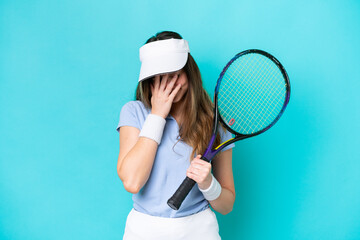 Young tennis player woman isolated on blue background with tired and sick expression