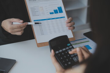 Entrepreneur Asian businessman and businesswoman discussing new business project in tablet in modern Meeting In Modern Office, Asian business casual concept.