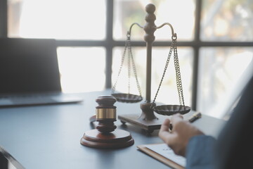 Business and lawyers discussing contract papers with brass scale on desk in office. Law, legal...