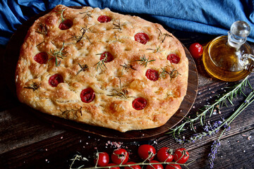 Italian focaccia bread with cherry tomatoes, garlic and rosemary
