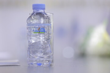 Plastic bottle of water on the table in the office with blurred background