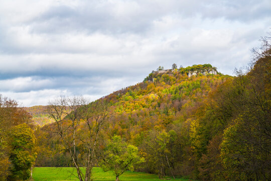 Germany, Colorful autumn colors forest trees nature landscape mountain at bad urach castle ruins hohenurach