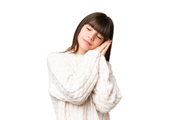 Little caucasian girl over isolated background making sleep gesture in dorable expression