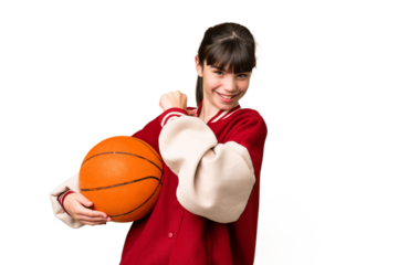 Little caucasian girl playing basketball over isolated background proud and self-satisfied