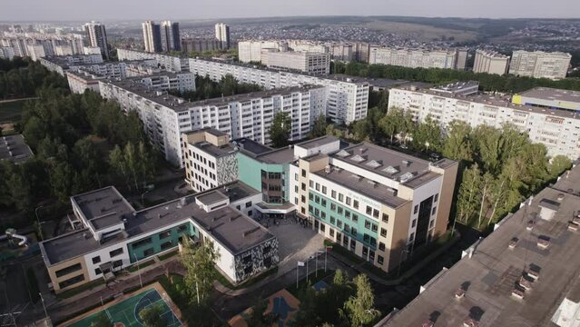 Cityscape of modern residential area with apartment buildings and playgrounds. New green urban landscape in big city aerial view