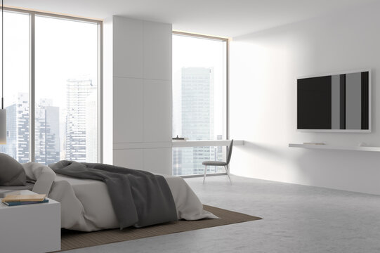 White stylish home bedroom interior with tv display and work space near window
