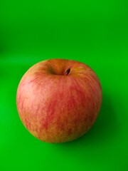 red apple on green background
