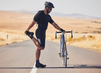 Man, cyclist and stretching on road with bicycle in fitness, training or outdoor sports in...