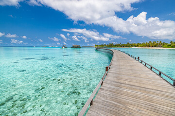 Aerial view of Maldives island, luxury water villas wooden pier path resort. Beautiful sky and...