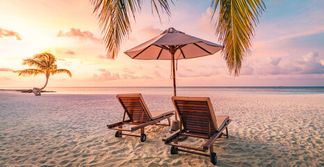 Romantic beach holiday, love couple destination scenic, chairs beds under umbrella, coco palm leaves. Exotic travel coast landscape. Panoramic island paradise vacation. Colorful sea sky, closeup sand - obrazy, fototapety, plakaty