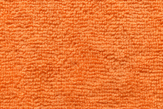 Orange microfiber cloth texture background. Textile surface texture. Soft fabric background.