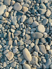 sea ​​stones pebbles lighting before sunset top view