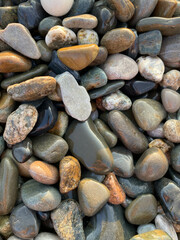 sea ​​stones pebbles lighting before sunset top view
