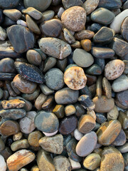 sea ​​stones pebbles lighting before sunset top view
