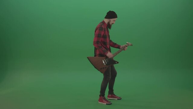 Guitarist play Gibson guitar in side view over green background