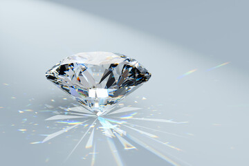 Diamond in a spotlight on white background with colorful refraction rays of light. Round brilliant cut stone standing on its point.