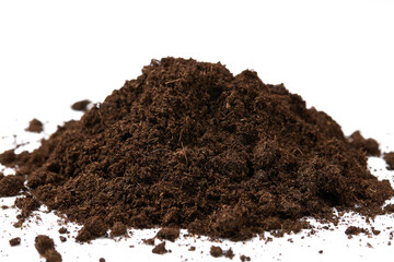 Heap of Peat Moss isolated on white background. Peat Moss is the remains of plants and animals that...