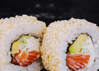 Japanese sushi rolls with salmon in rice and sesame