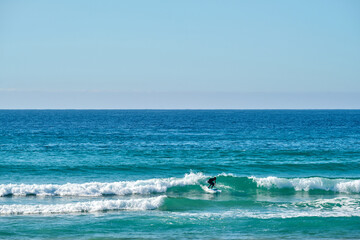 Person surfing the waves in Tarifa Spain