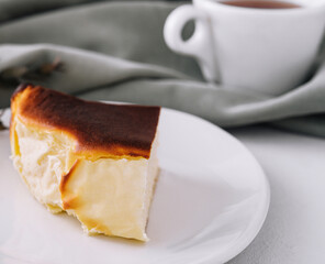 San sebastian cheesecake on plate with tea