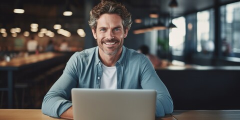 Fototapeta premium Businessman smiling using laptop computer sitting at worktable at modern office. Happy man, entrepreneur, small business owner working online, generative ai