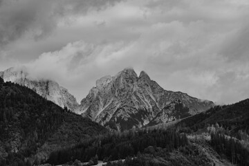Alps mountains in clouds, black and white