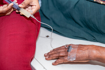 Nurse Administering IV Injection to Elderly Woman