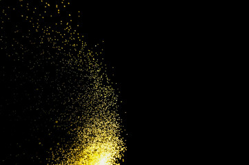 abstract powder splatted background. yellow powder explosion on black background. Colored cloud....