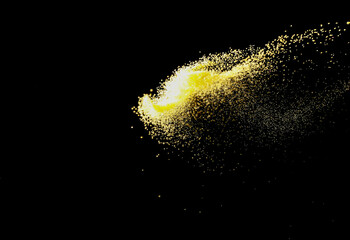 abstract powder splatted background. yellow powder explosion on black background. Colored cloud....
