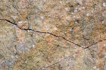 Grunge abstract background, close up photography of brown textured stone with cracks. Copy space, place for text.
