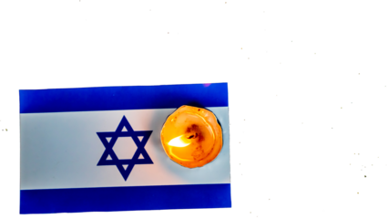 Israeli flag and candles burning above it, Holocaust memory day