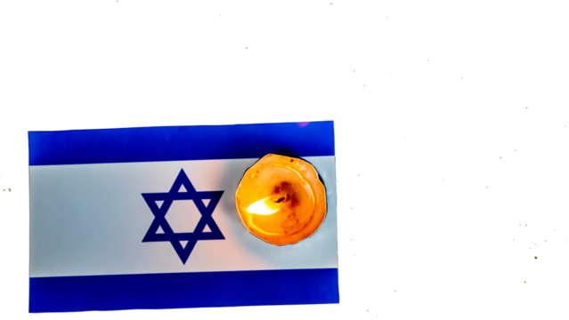 Israeli flag and candles burning above it, Holocaust memory day