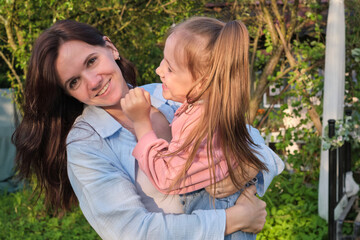 Lifelong Bonds: In the warmth of a sunlit garden, the foundation of a lifelong bond is formed, as a mother and daughter share joyous moments of connection.