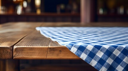 Blurred Background of a blue and white checkered Tablecloth on a wooden Table