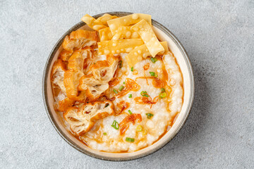 Rice porridge or congee with cakwe in bowl