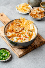 Rice porridge or congee with cakwe in bowl