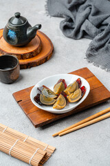 preserved duck eggs or century eggs cut in parts on a white plate