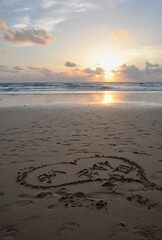 Beach at sunset with heart drawn in sand, Kata beach, Phuket, Thailand