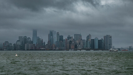 Obraz premium Manhatten skyline on a cloudy, overcast, autumnal day. The top of the Freedom tower is obscured by low level clouds