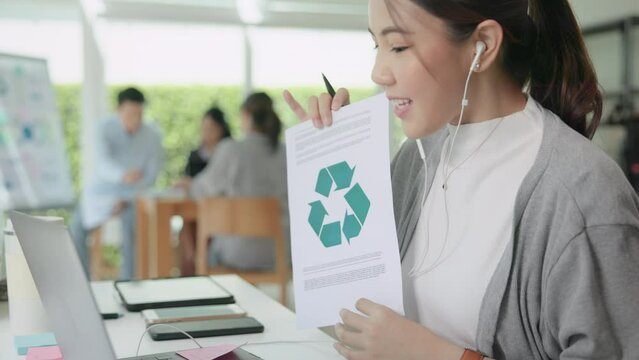 Save the planet earth of Future growth Net zero waste ESG office SME global protect CO2 emission social issues project. Young woman asia people teaching advice Eco friendly SDGs job on laptop seminar.